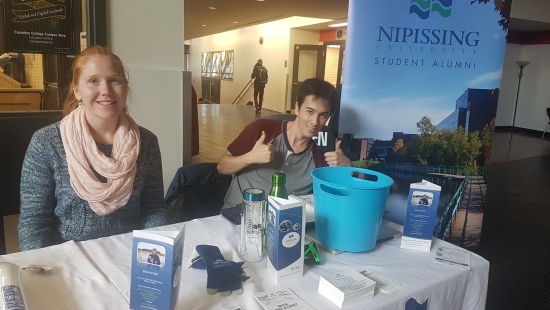 NUSA volunteers at a table in the Education Centre lobby