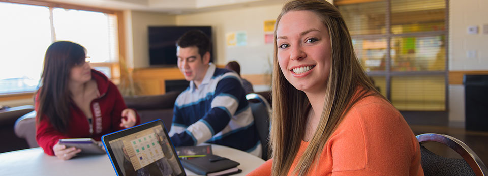 student at table with laptop