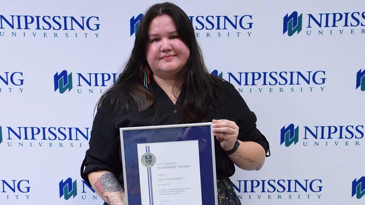 Emily Otowadjiwan with award