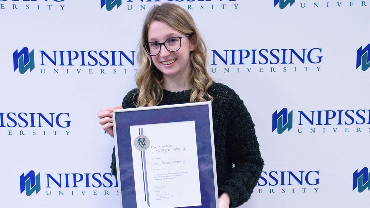 Sarah Pecoskie-Schweir with award