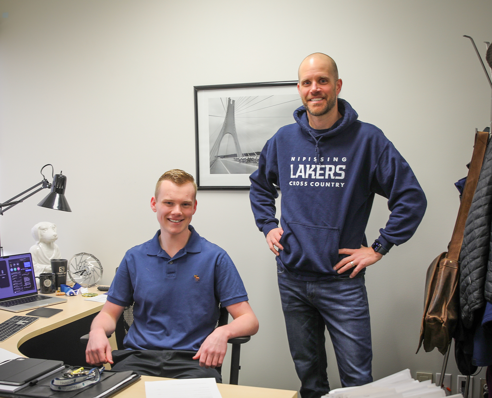 Graydon and student Kyle, sit at Graydon's desk