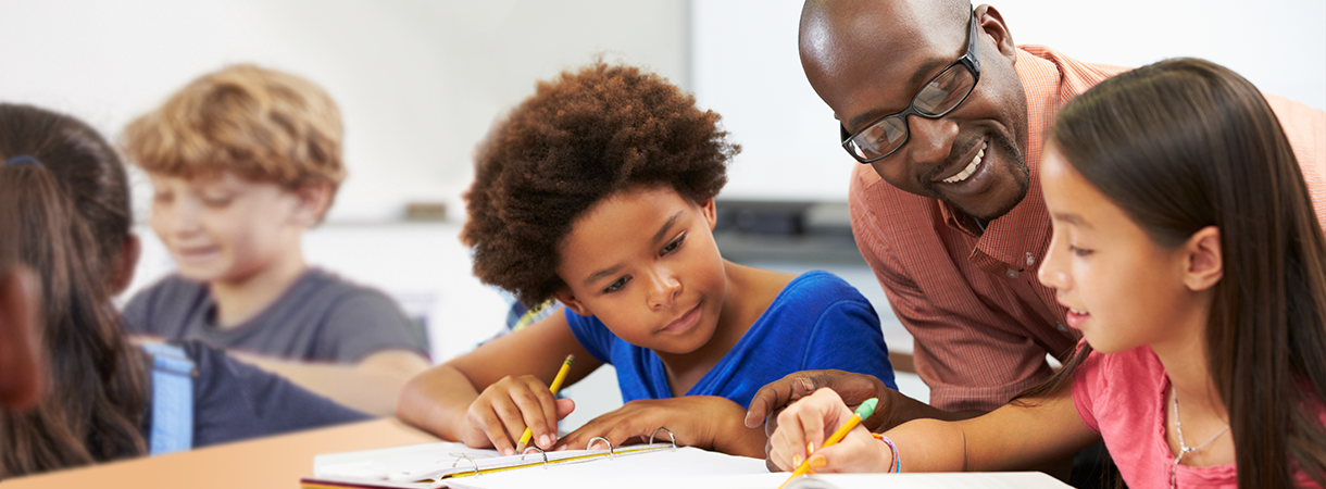 A teacher working with students in a classroom