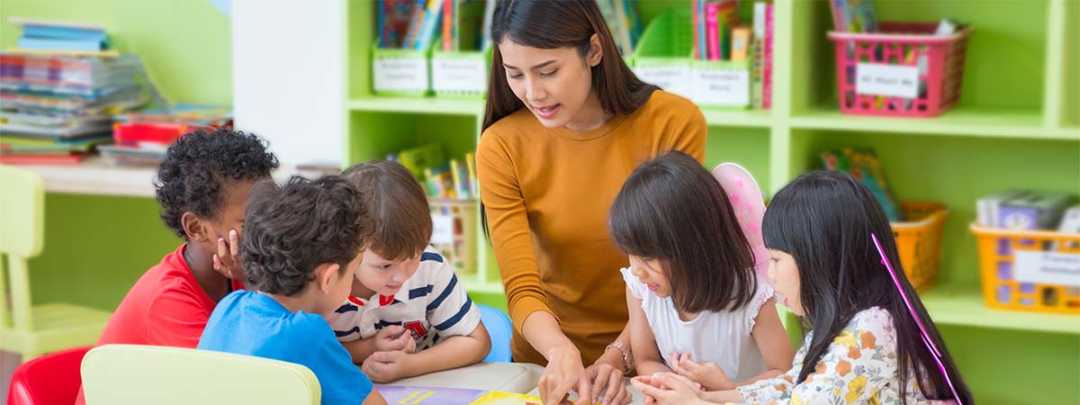 A teacher working with students in a classroom