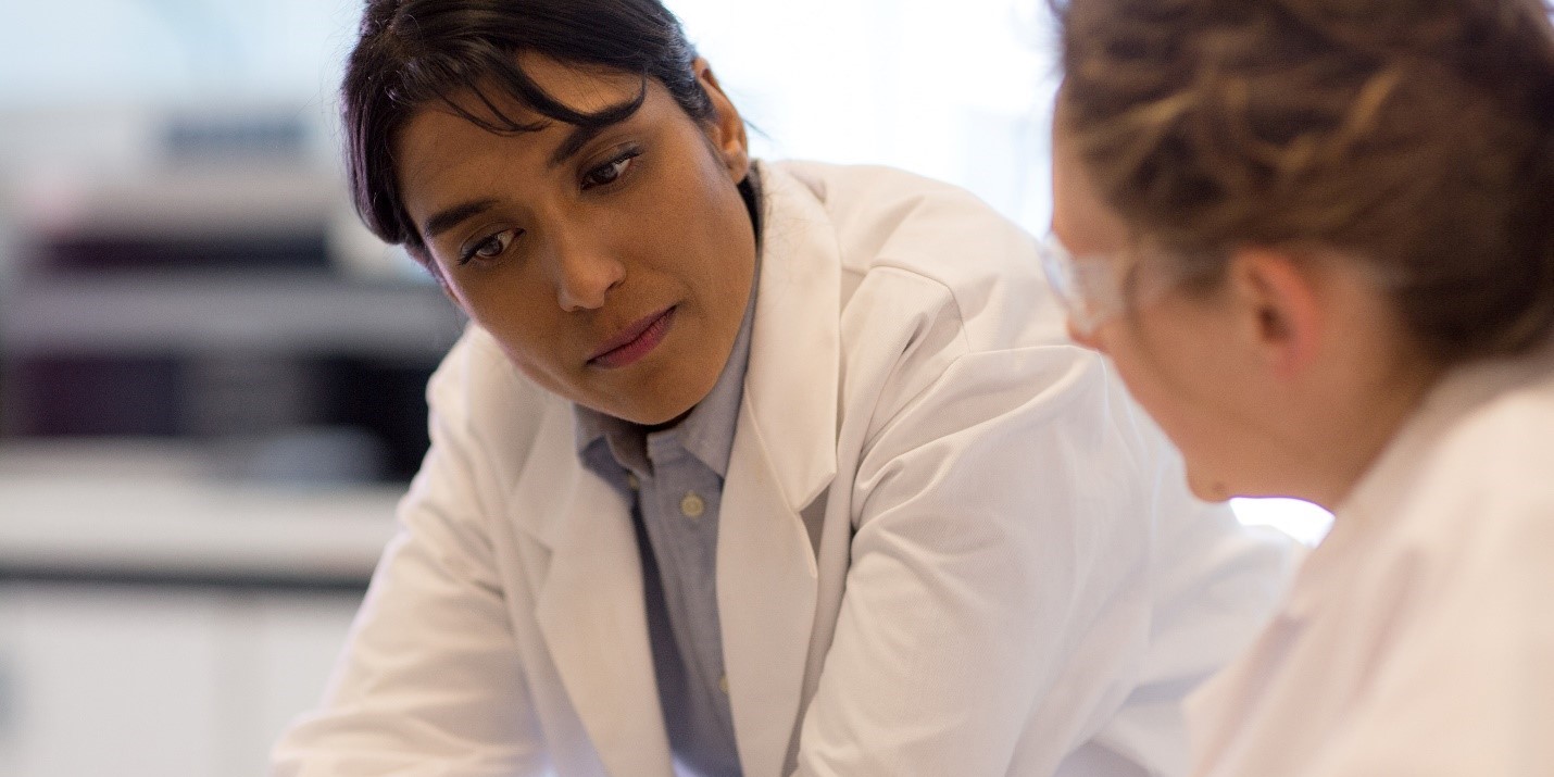 Two researchers discussing a question