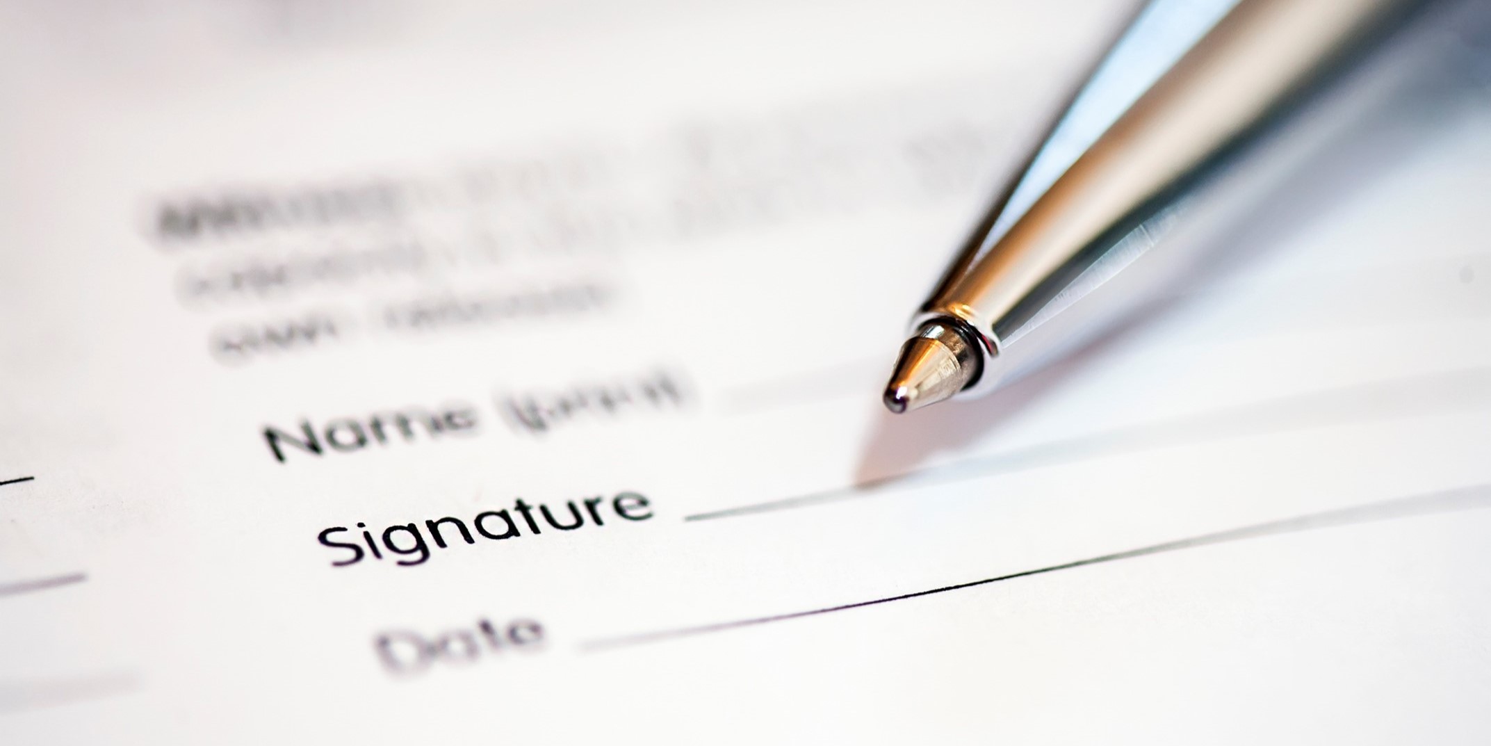 Form with a pen beside the signature line