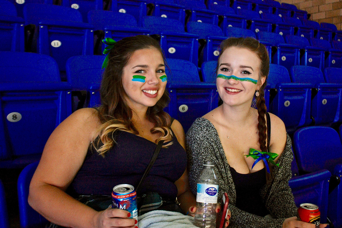 Two people at Hockey game stands