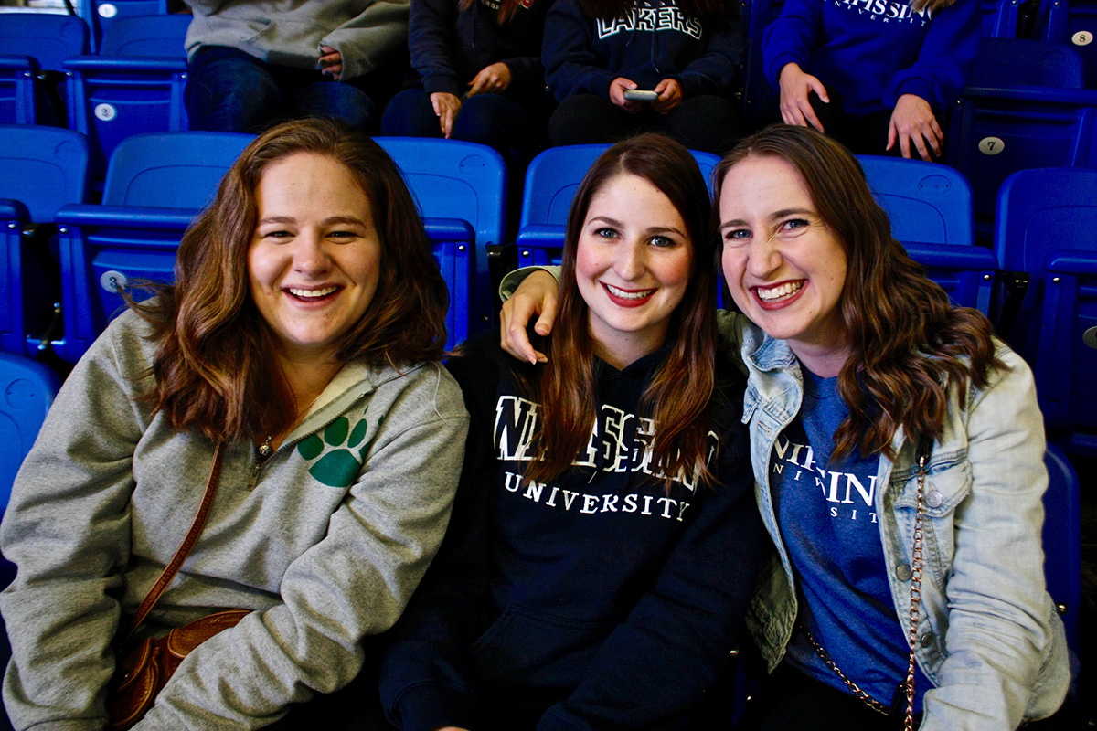 Three people at Hockey game
