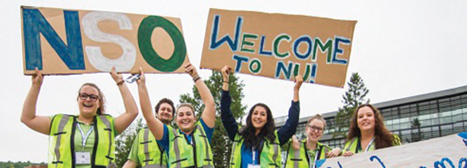 NSO student volunteers with welcome signs
