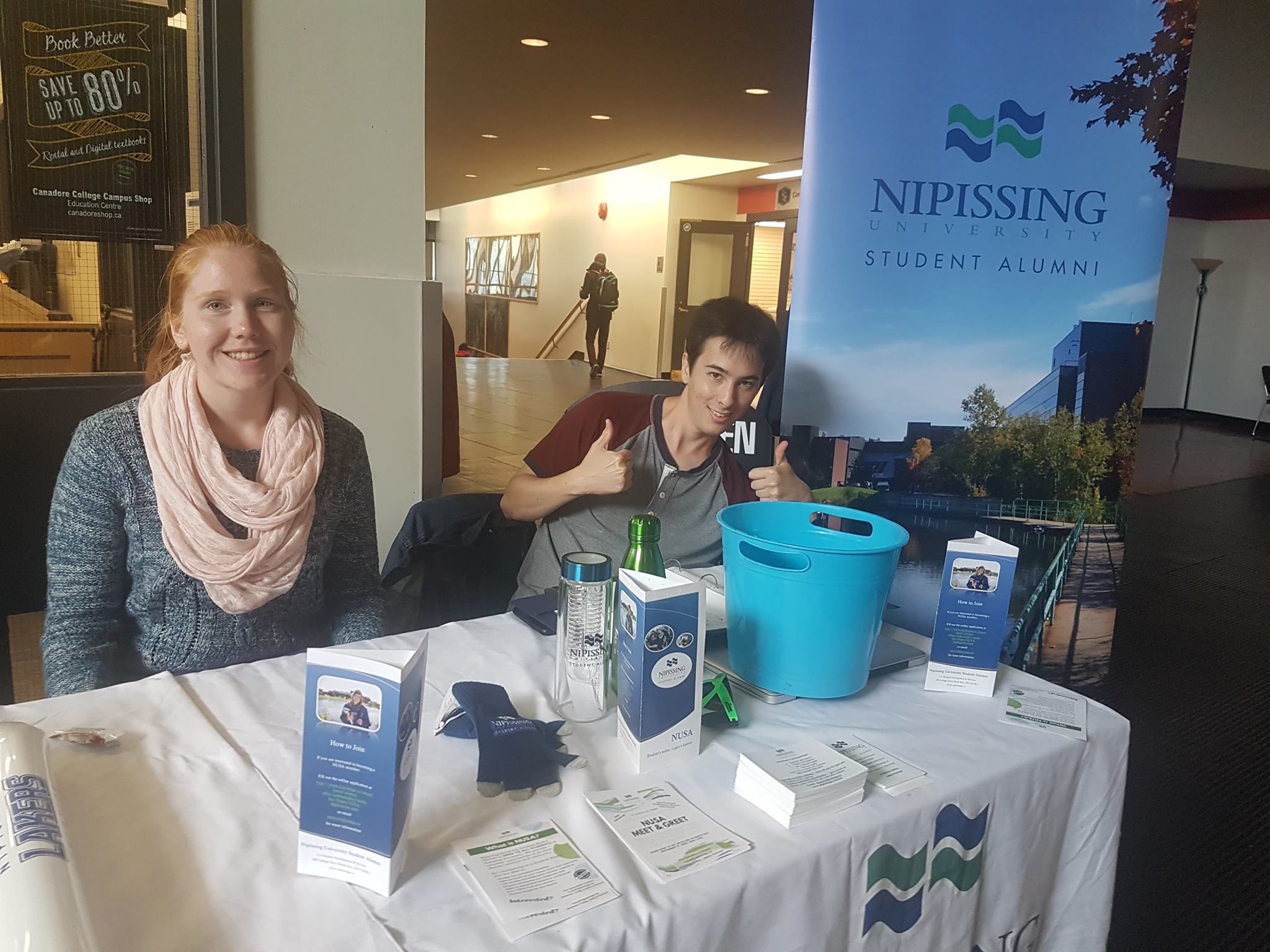 NUSA volunteers at a table in the Education Centre lobby