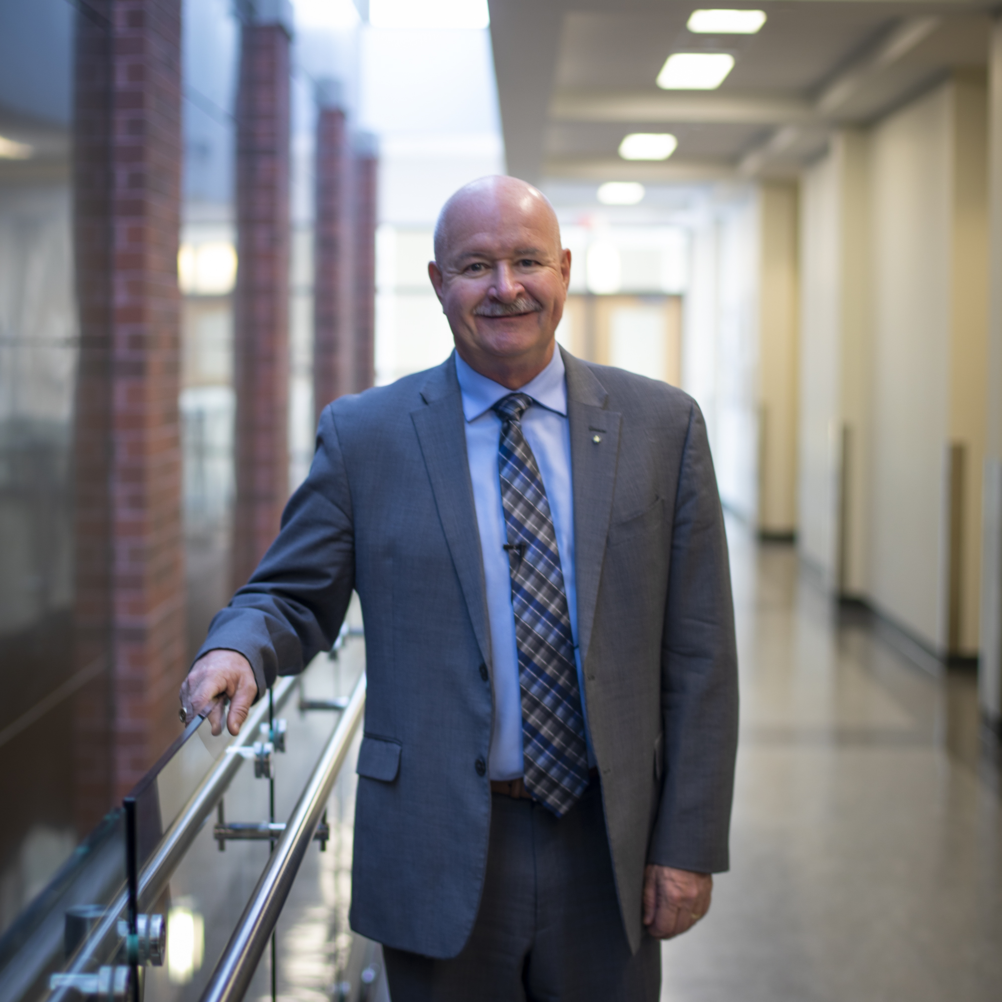 Chancellor Dr. Paul Cook stands in the hallway at Nipissing University