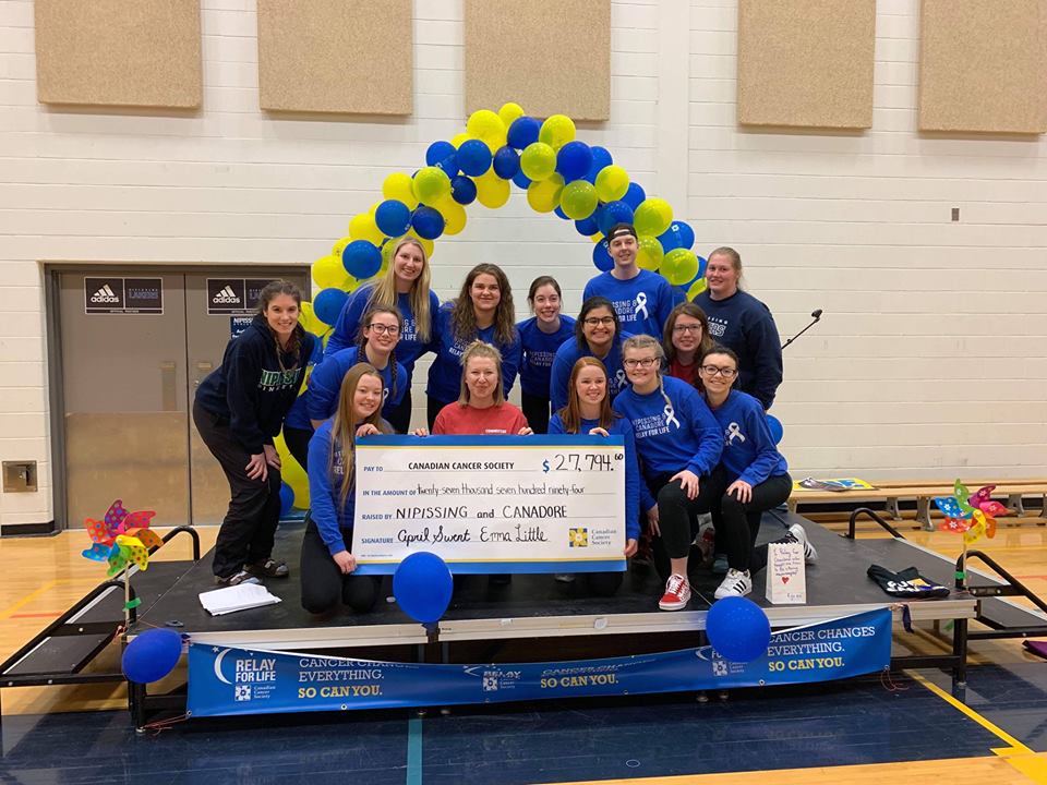 Picture of a group of students in front of balloons for Relay for Life