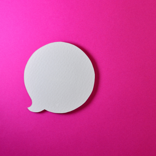 Pink Background with white paper cut out of speech bubble.