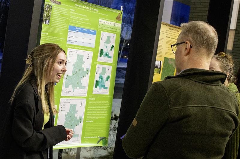 Students and community members networking and showcases research posters