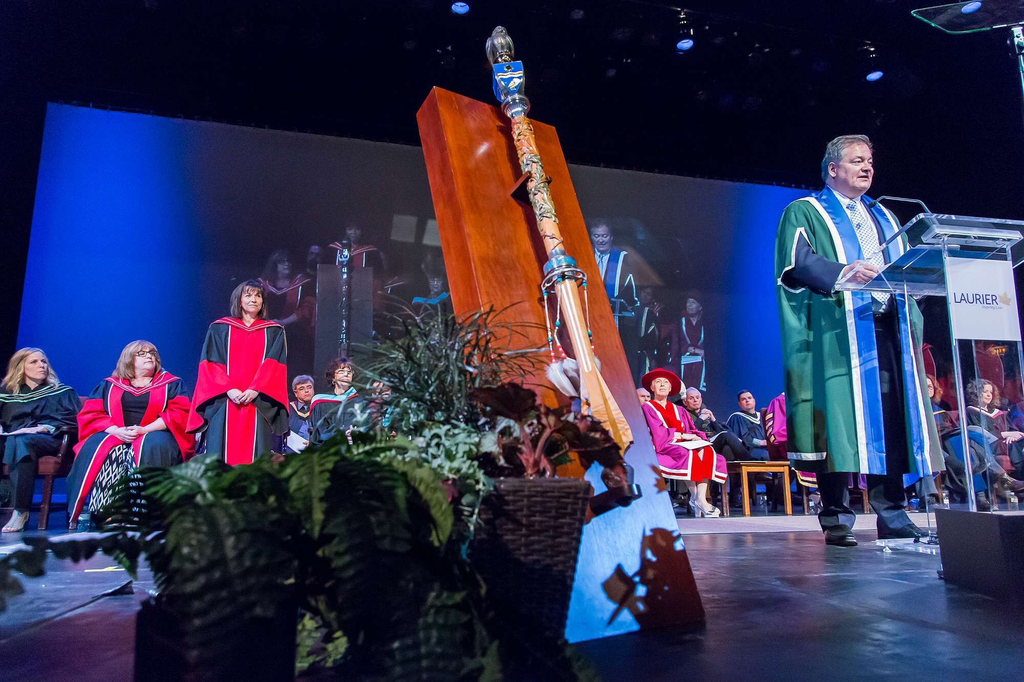Dr. Maria Cantalini-Williams on stage with mace and president