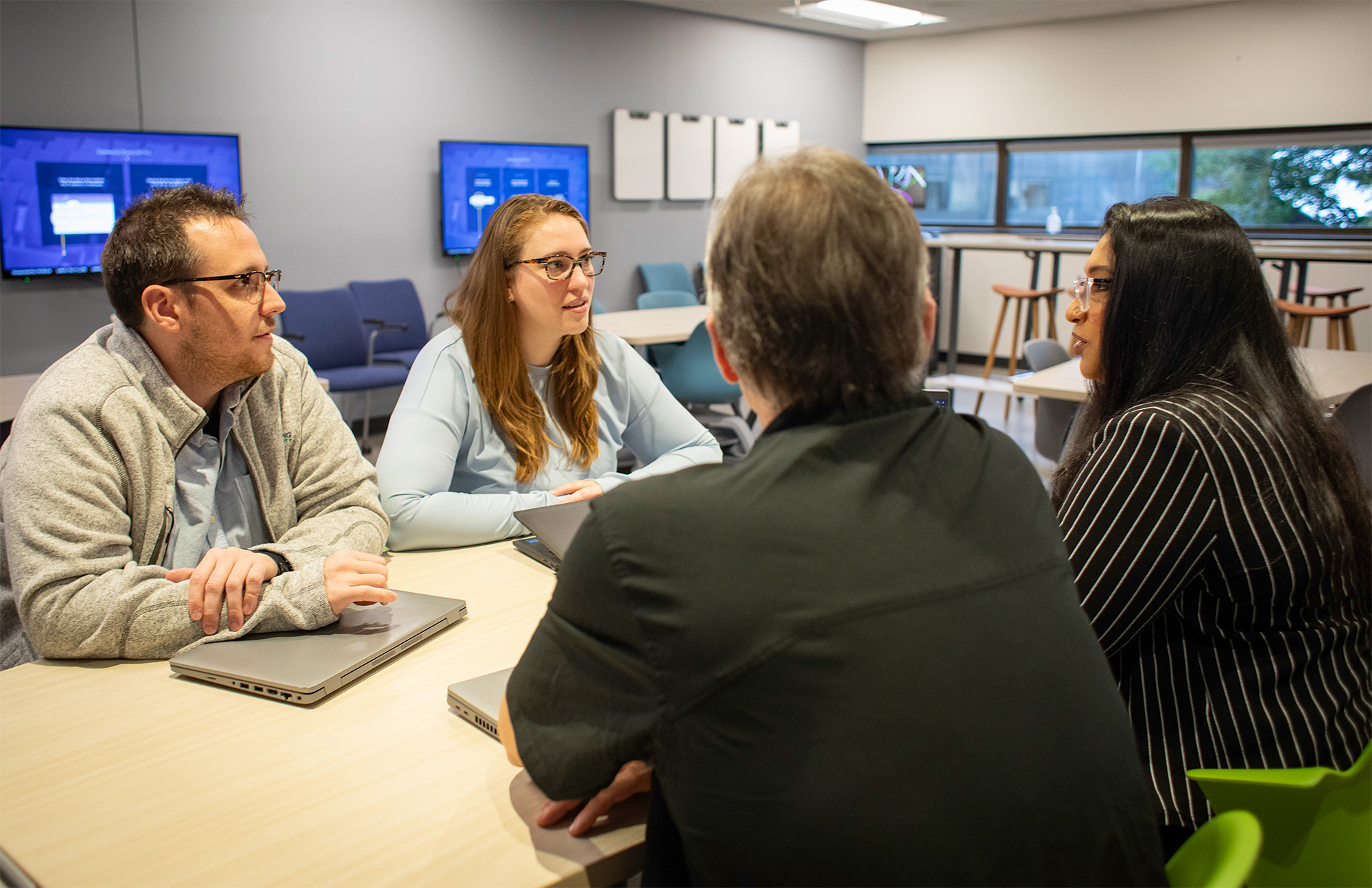 A group of staff chatting in an office setting