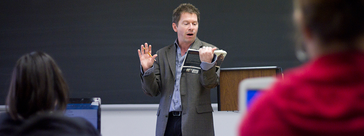 a professor reading during a lecture