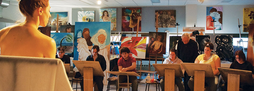 students painting in a classroom
