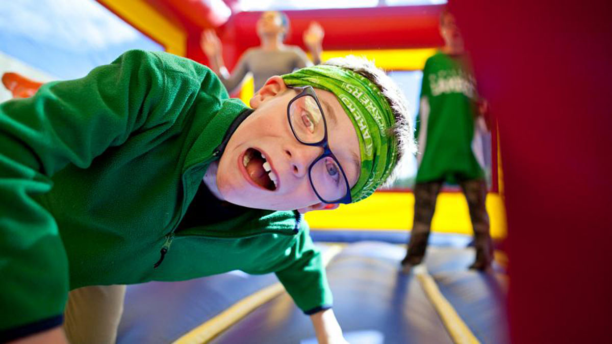 Youth on bouncy castle.