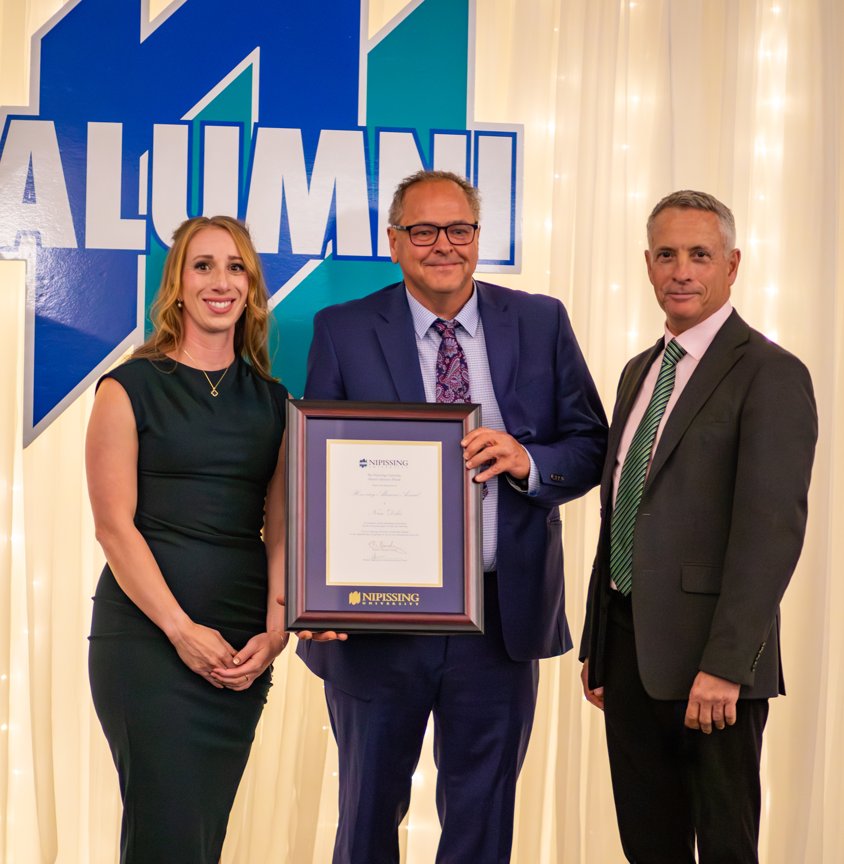 Norm Dokis receiving the Honorary Alumni Award