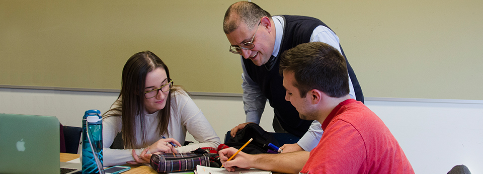 a professor helping two students
