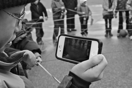 Black and white photo of a person looking at their phone