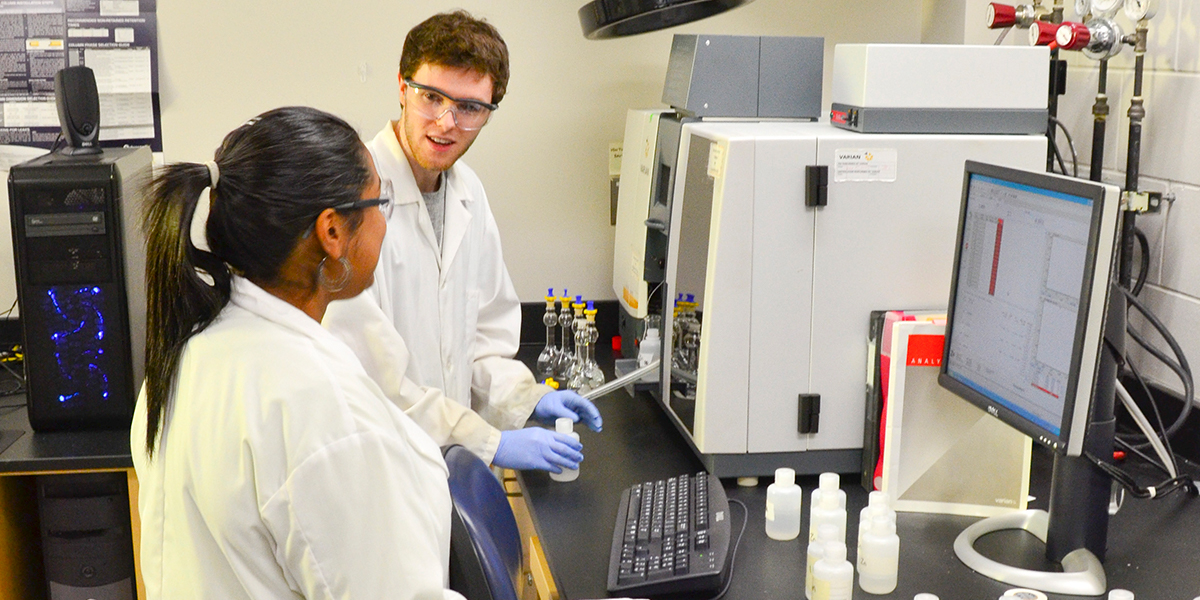 two students in lab coats