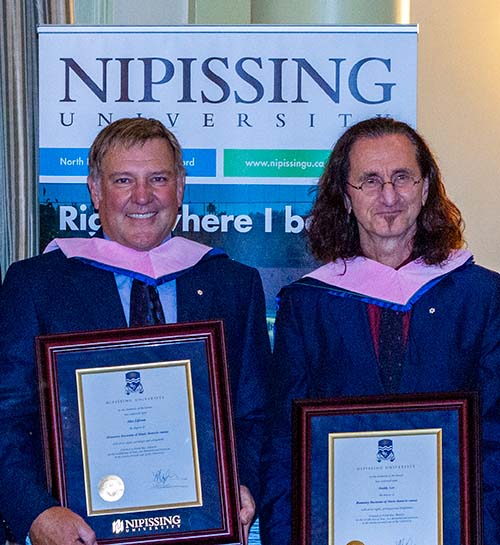 Alex Lifeson and Geddy Lee with degrees