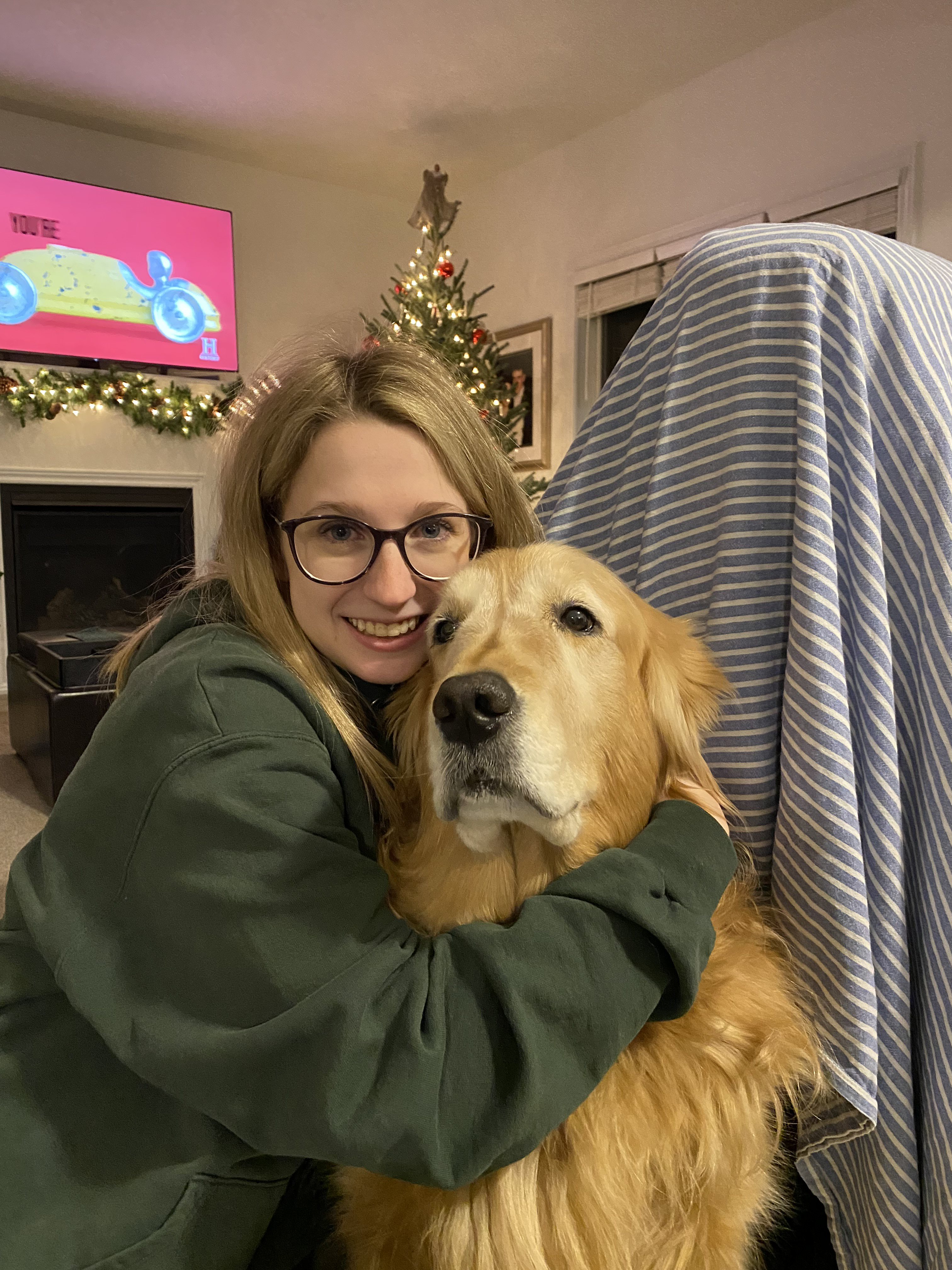 Sarah Pecoskie Schweir hugs a golden retriever.