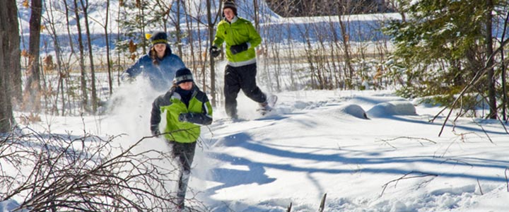 student running in the snow in snowshoes 