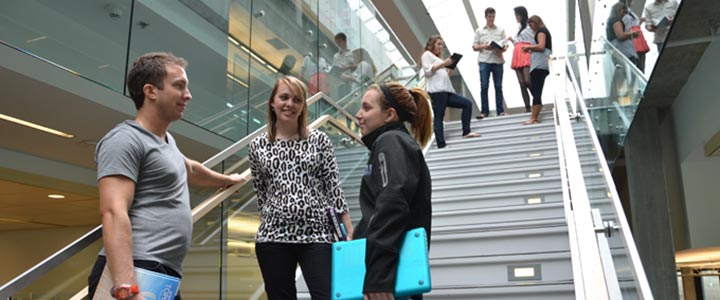 students talking in the library