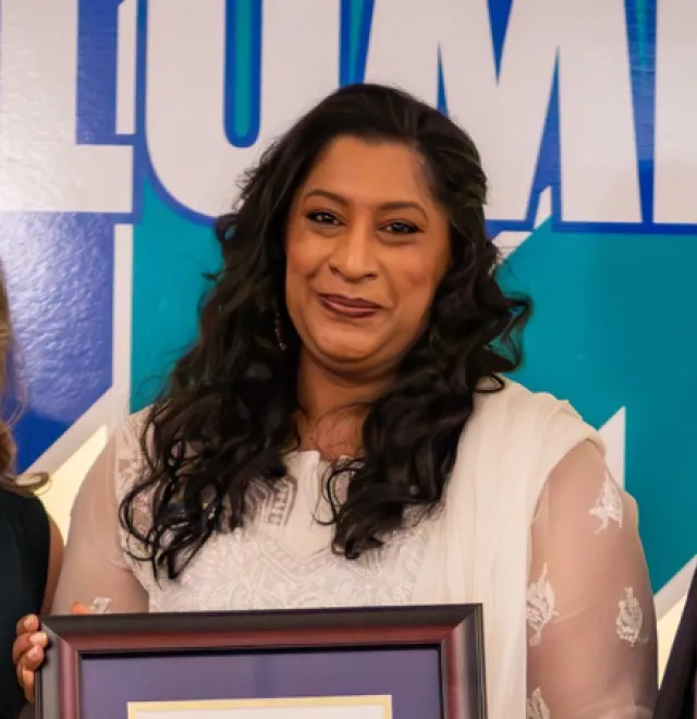 Sabah Khan is presented with the Dr. James Jamieson Alumni Award by Laurel Muldoon and Dr. Kevin Wamsley