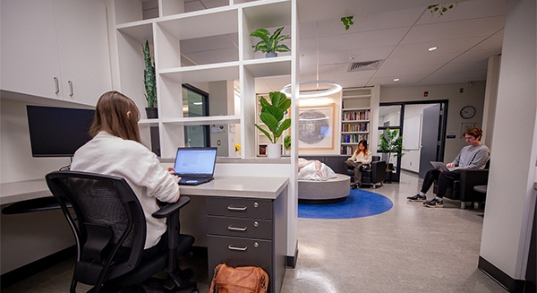 C-WAG space with 3 students doing work and reading books inside