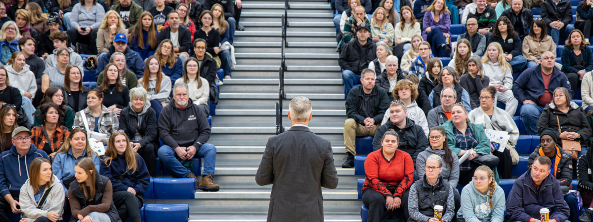 Dr. Kevin Wamsley addresses the packed bleachers in front of him, filled with guests attending the Fall Open House event.