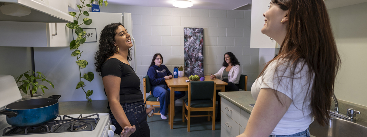 A group of NU students socializing in residence kitchen