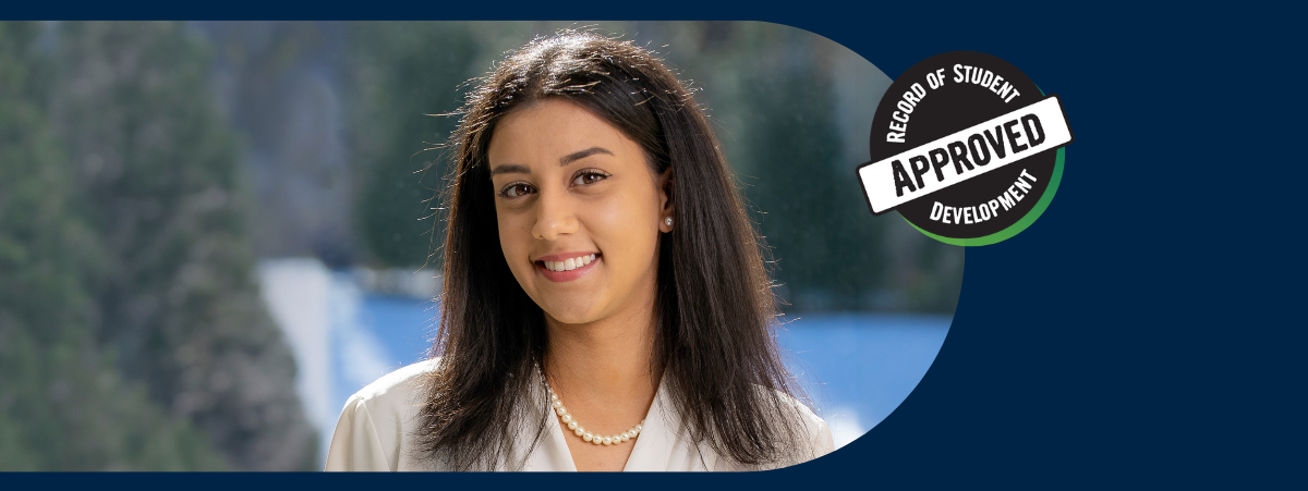 Priya smiling into the camera with a snowy background