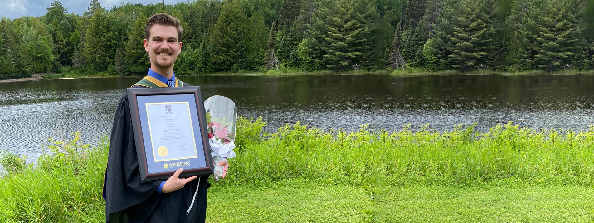 Graduate with framed Degree