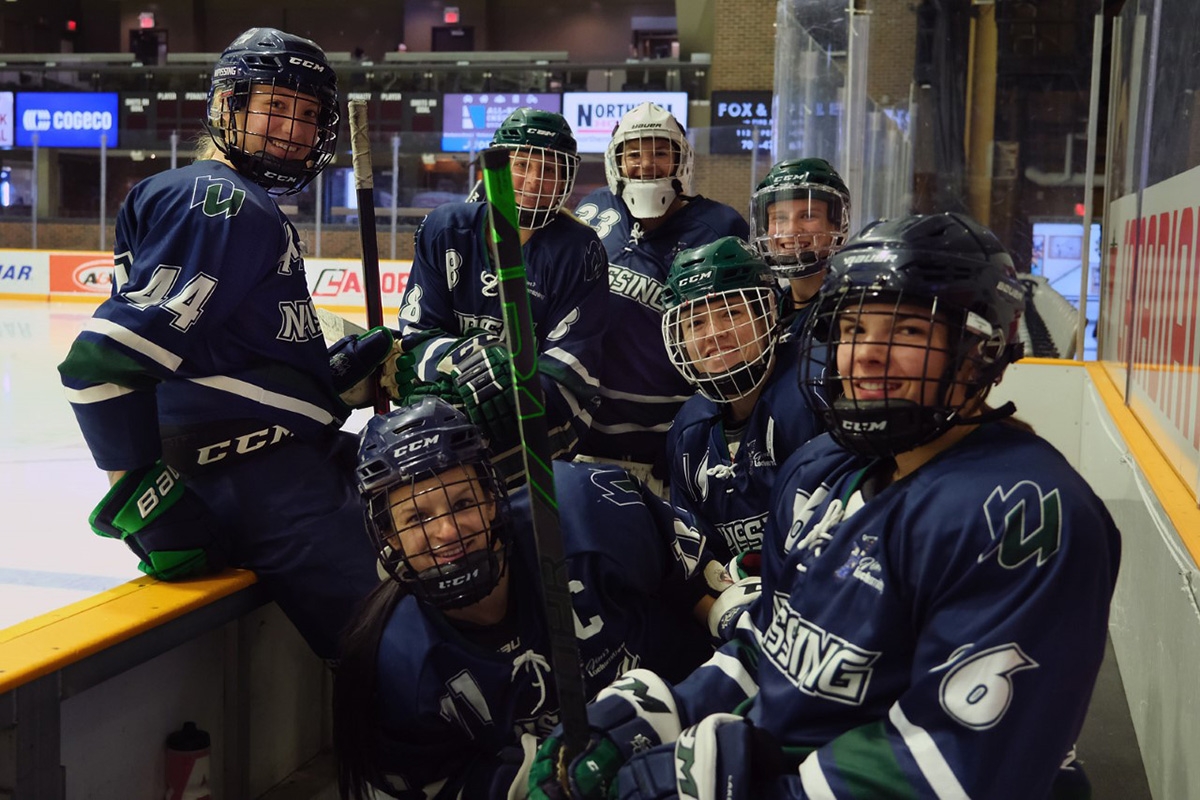 Women's Hockey team on bench
