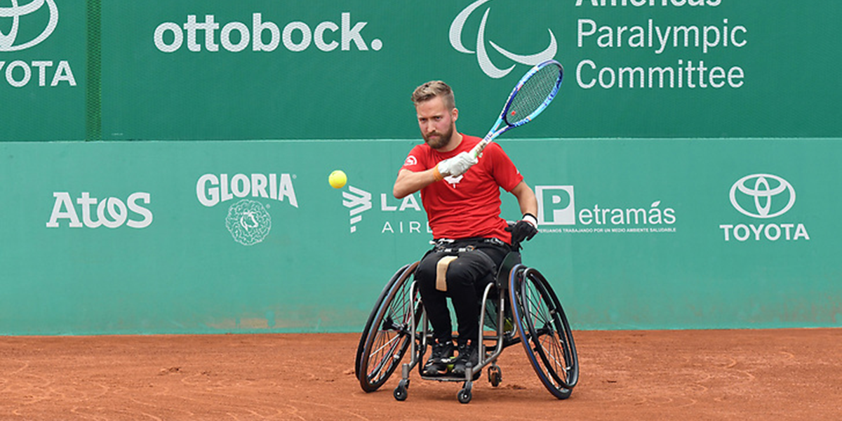Rob Shaw, wheelchair tennis athlete returns a shot during competition