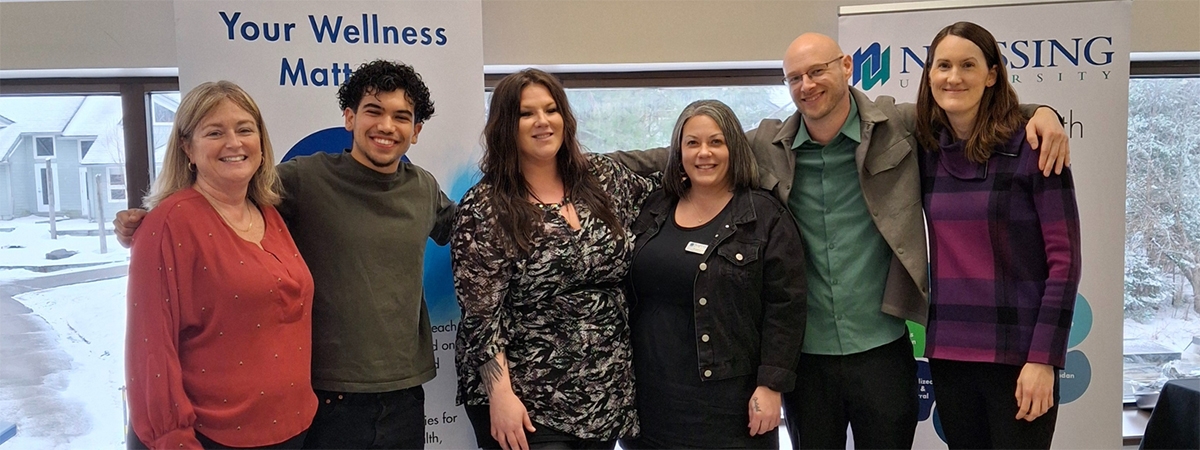 Hosts of the event stand together in a group photo