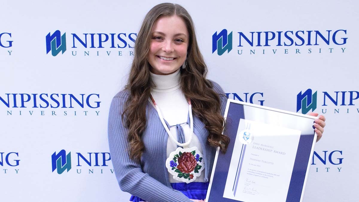 Hannah Turcotte with DMLA award