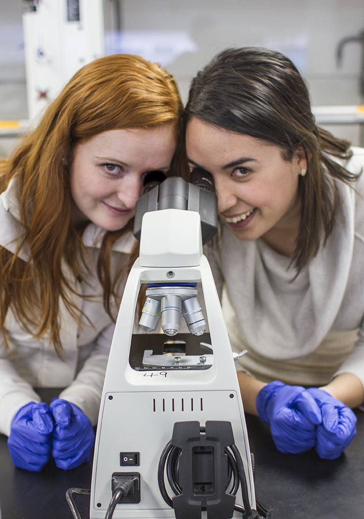 Photo of Hilary and Kat looking in a microscope