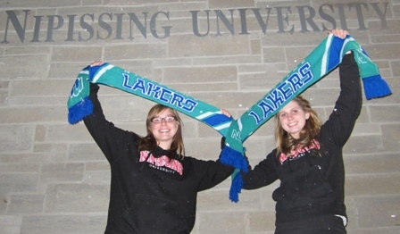 Photo of students holding up Lakers scarves