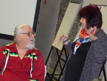 Larry McLeod speaking with woman at conference