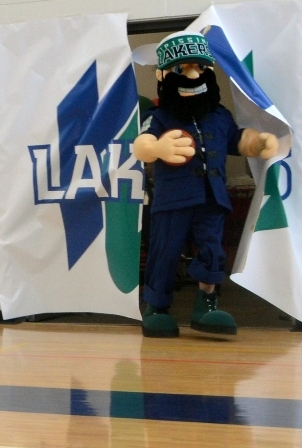 Photo of Louie the Laker busting through a giant Lakers logo