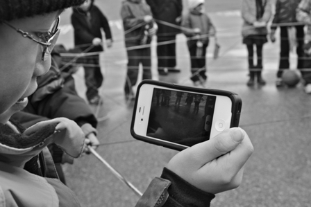 Black and white photo of a person looking at their phone