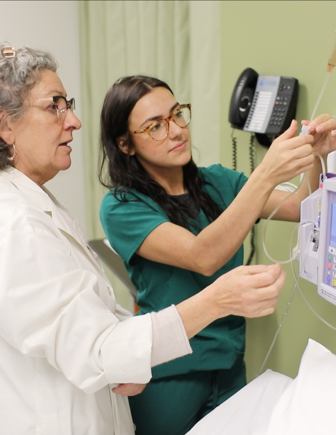 A nursing professor and student working in the simulation lab