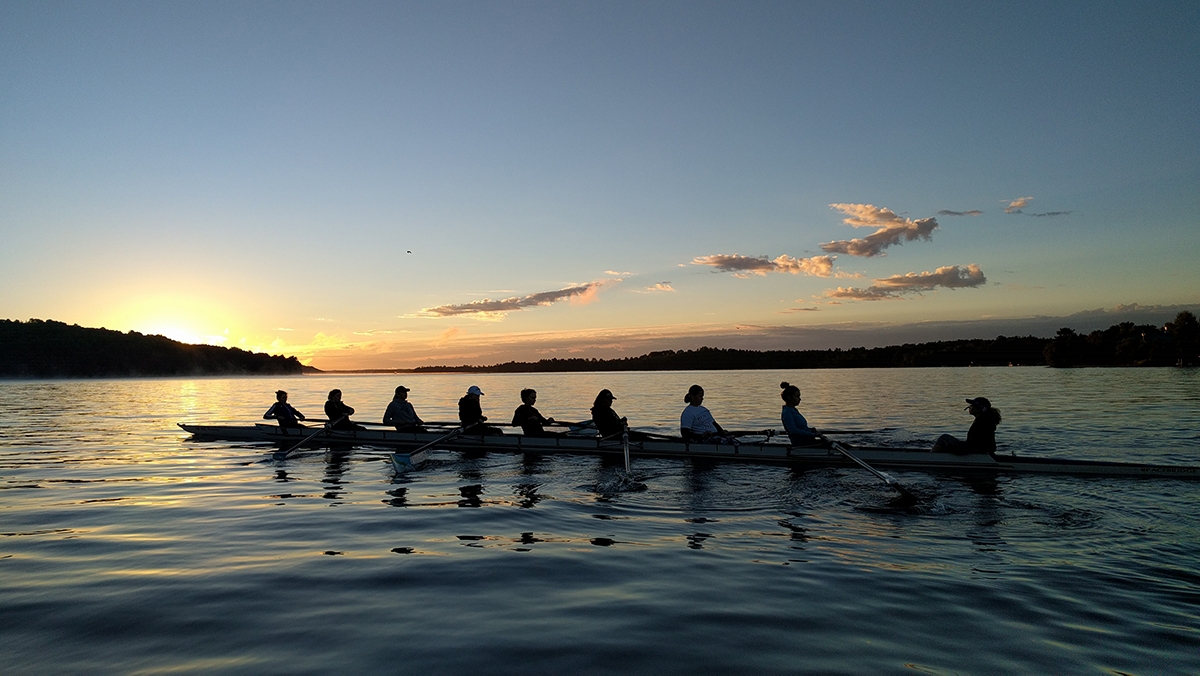 varsity rowing team on the water