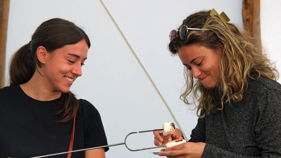 Roasting marshmellows in the Library Teepee during Homecoming weekend