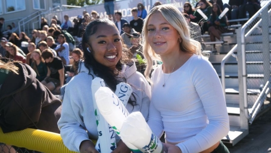 Two Lakers with thunder sticks during NU Homecoming 2025