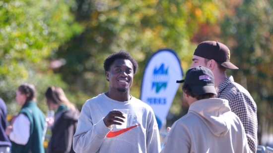 Lakers socializing outdoors during NU Homecoming 2025